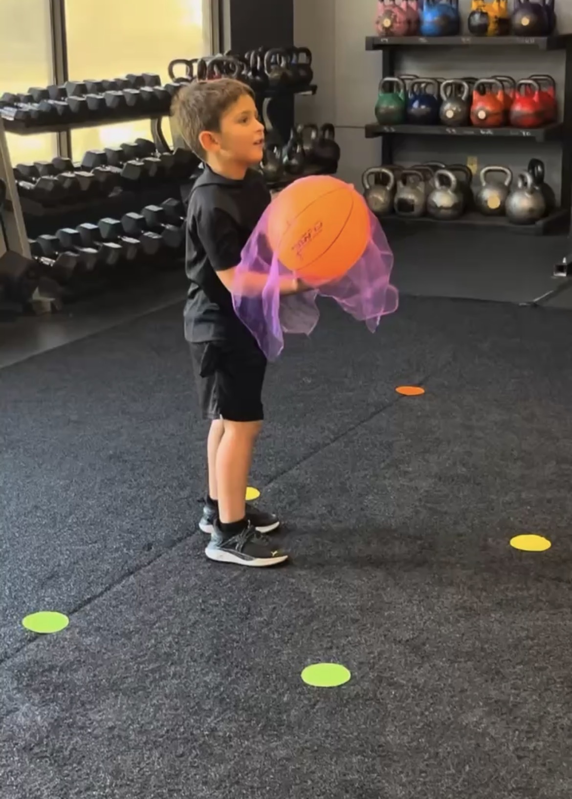 Young boy with medicine ball at Power Play PE Sacramento gym preschool class