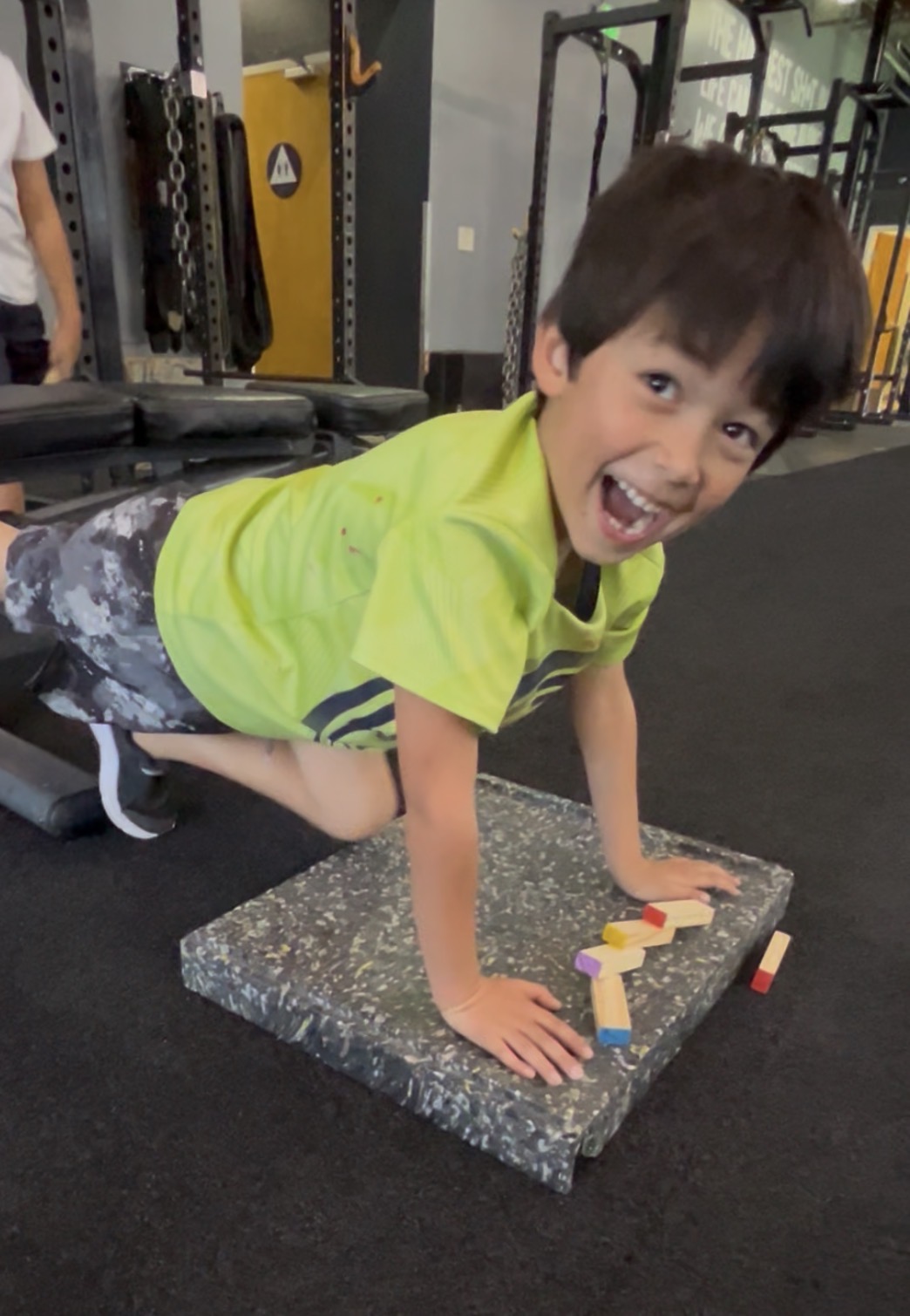 Young boy doing pushup at Power Play PE Little Movers preschool class Sacramento