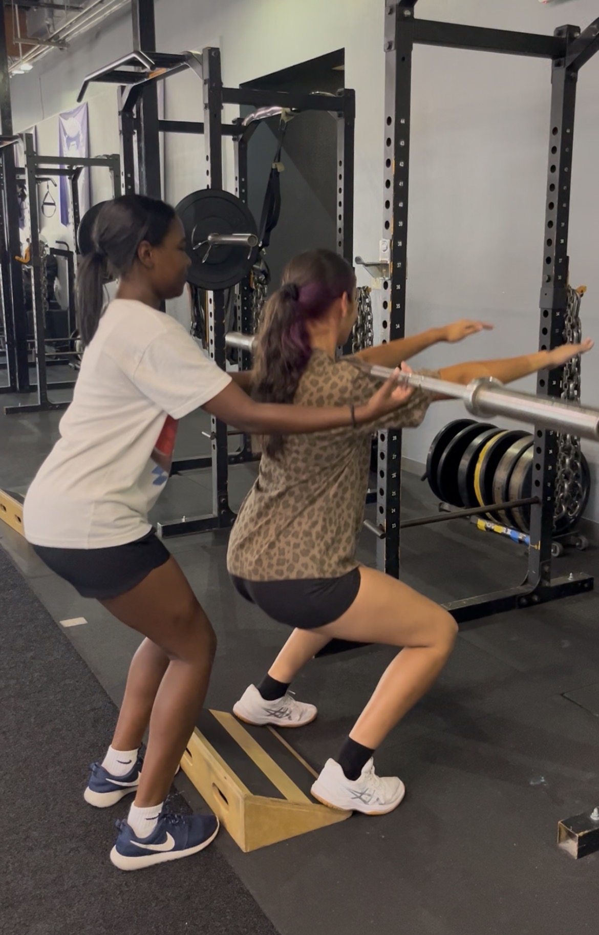 Teen girls learning barbell squat with coaching at ISC Sacramento