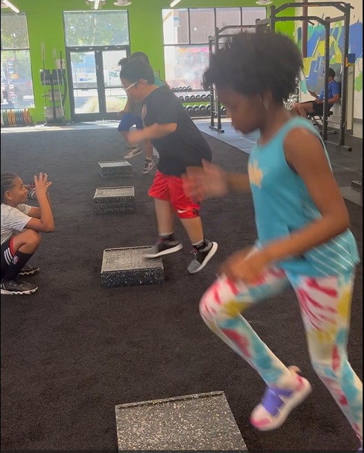 Kids in group huddle at Power Play PE homeschool physical education Sacramento
